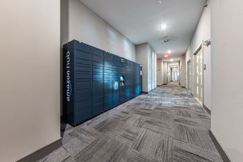 A long hallway with blue lockers in the middle of it
